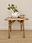 Vintage Tiger Bamboo side table with woven top, styled with a ceramic swan planter and pottery mug 