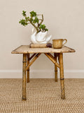 Vintage Tiger Bamboo side table with woven top, styled with a ceramic swan planter and pottery mug 
