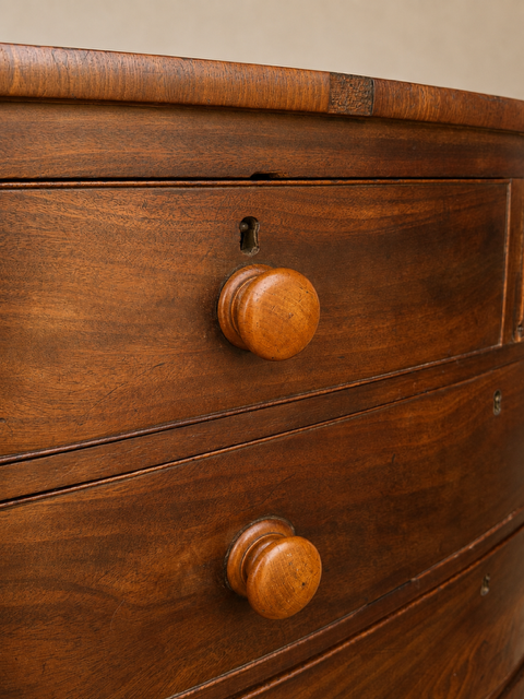 Antique mahogany chest  of drawers showing original wooden drawer handles and patina 
