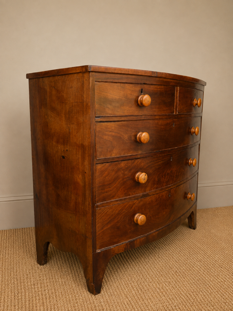 Antique bow front mahogany chest of drawers viewed from the side 
