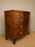 Antique bow front mahogany chest of drawers viewed from the side 