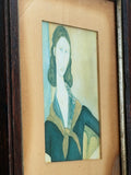 Angled ochre mount, metallic inner trim close up of a vintage Modigliani portrait print of Jeanne, showing the ochre mount, metallic inner trim and dark wooden frame 